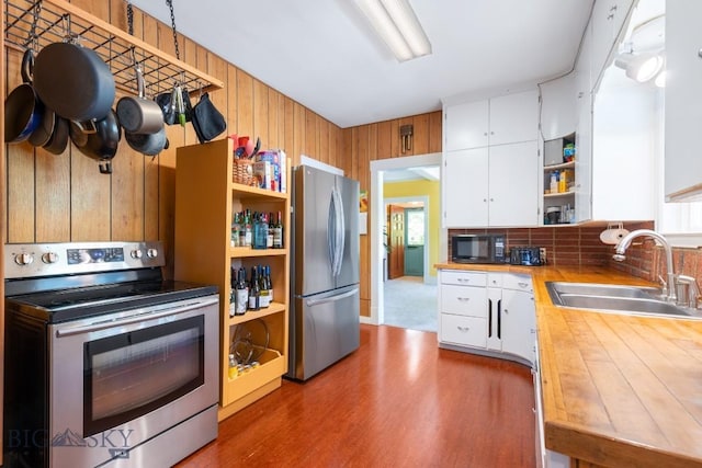 602 S 6th Ave, Bozeman, MT 59715 - kitchen with stainless steel appliances, open shelves, a sink, white cabinetry, and decorative backsplash