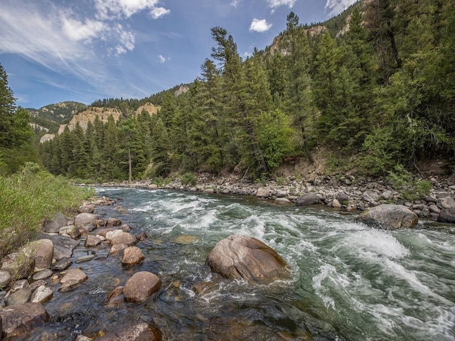 64370 Gallatin Rd, Gallatin Gateway, MT 59730 - water view with a forest and a mountainous background