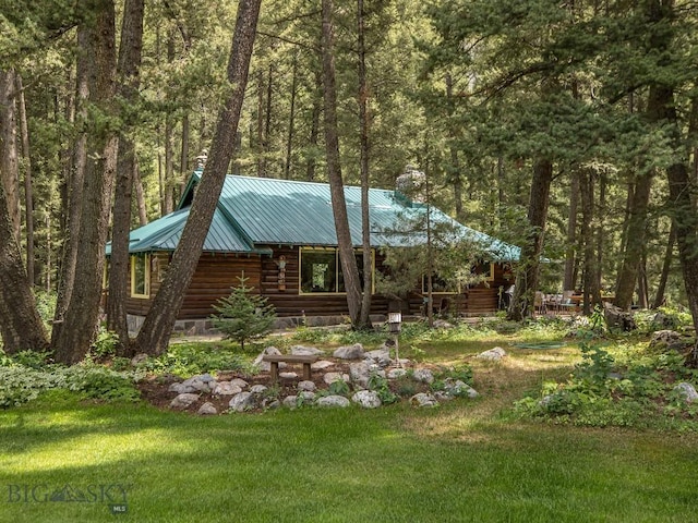 64370 Gallatin Rd, Gallatin Gateway, MT 59730 - view of front of property with a metal roof, a forest view, a front yard, and log siding