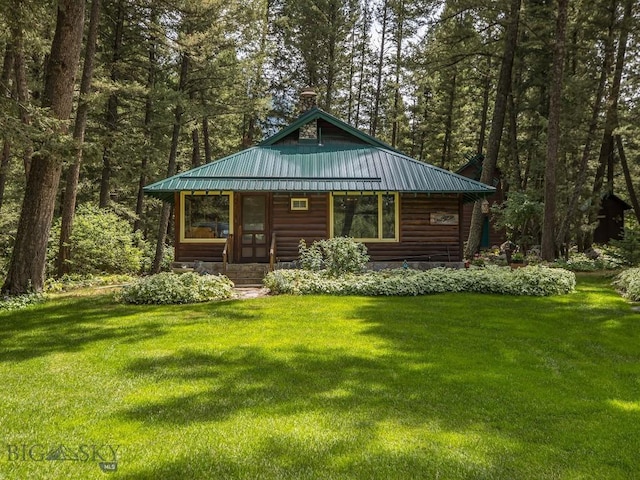 64370 Gallatin Rd, Gallatin Gateway, MT 59730 - view of front of property with a front lawn, faux log siding, a metal roof, and a view of trees