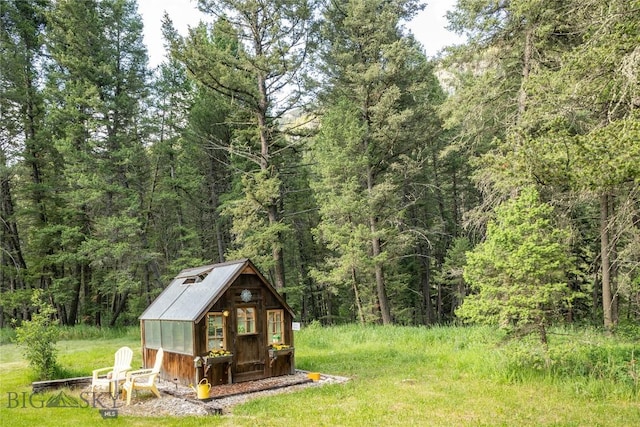 64370 Gallatin Rd, Gallatin Gateway, MT 59730 - view of outdoor structure featuring a view of trees