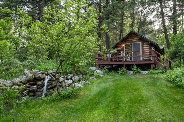 64370 Gallatin Rd, Gallatin Gateway, MT 59730 - rear view of property with log exterior, a deck, a view of trees, and a yard