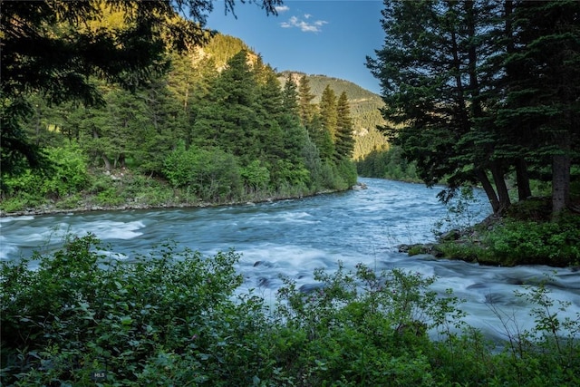 64370 Gallatin Rd, Gallatin Gateway, MT 59730 - water view featuring a heavily wooded area and a mountainous background