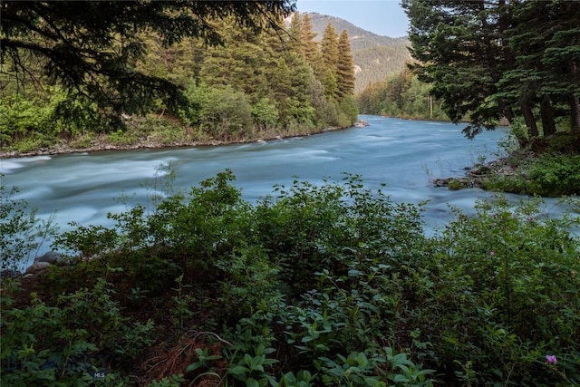 64370 Gallatin Rd, Gallatin Gateway, MT 59730 - water view featuring a forest and a mountain backdrop