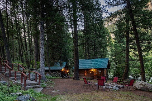 64370 Gallatin Rd, Gallatin Gateway, MT 59730 - view of yard featuring a view of trees and an outdoor fire pit
