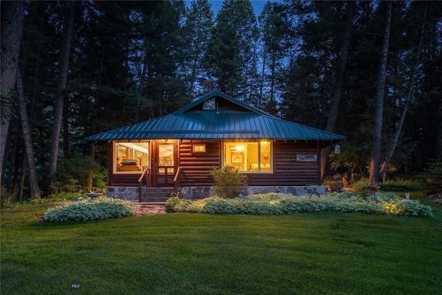 64370 Gallatin Rd, Gallatin Gateway, MT 59730 - view of front of house with a front lawn, a metal roof, a forest view, and a porch