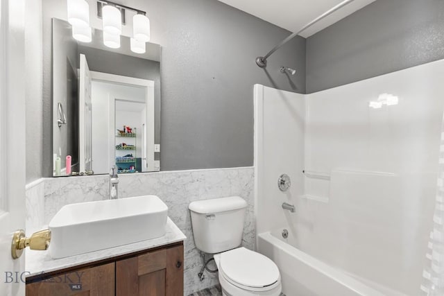 85 Shallow Brook Ln, Belgrade, MT 59714 - bathroom with tile walls, bathing tub / shower combination, vanity, and wainscoting