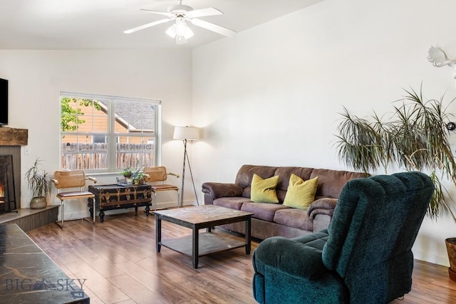 85 Shallow Brook Ln, Belgrade, MT 59714 - living area featuring a fireplace, wood finished floors, and a ceiling fan