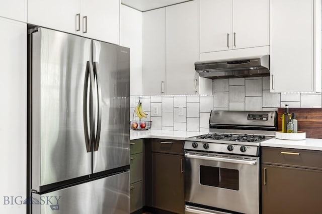 85 Shallow Brook Ln, Belgrade, MT 59714 - kitchen featuring appliances with stainless steel finishes, ventilation hood, light countertops, decorative backsplash, and white cabinets