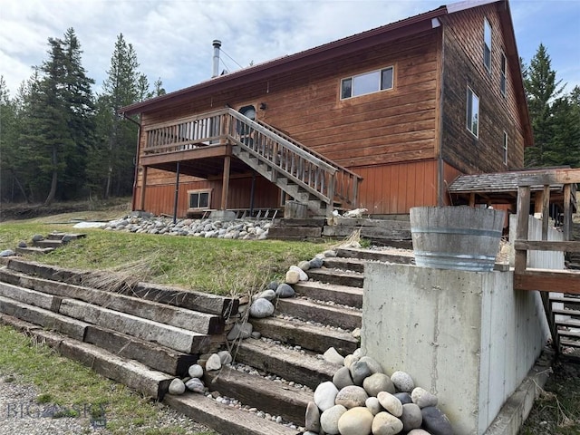 3030 Woodchuck Rd, Bozeman, MT 59715 - rear view of house with stairs and a wooden deck