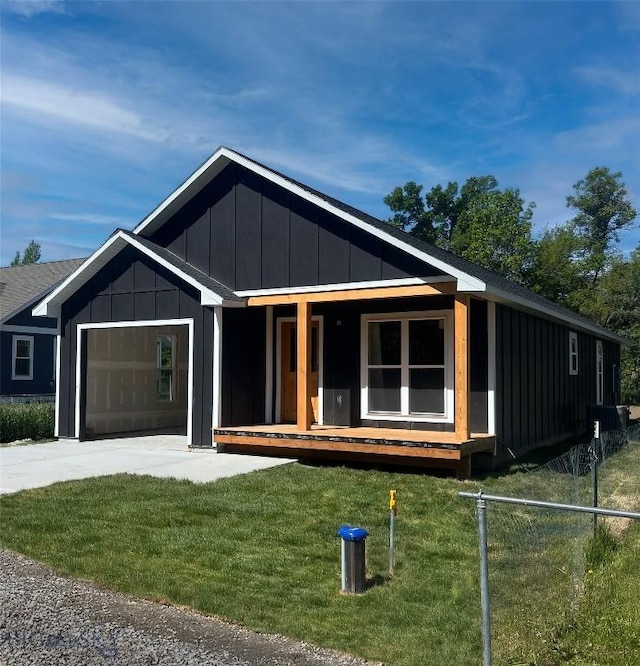 507 Broadway St, Willow Creek, MT 59760 - view of front of home featuring covered porch, board and batten siding, a garage, and driveway