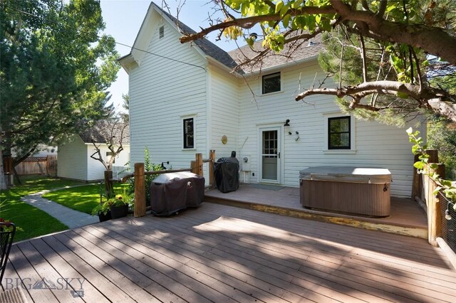 311 N 6th St, Manhattan, MT 59741 - back of house featuring a hot tub, a wooden deck, and roof with shingles