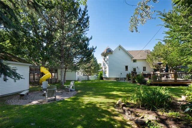 311 N 6th St, Manhattan, MT 59741 - view of yard featuring a playground, a deck, and a patio area