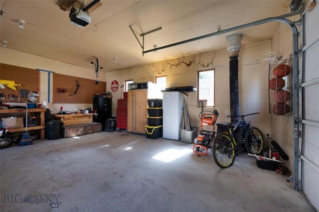 311 N 6th St, Manhattan, MT 59741 - garage with a garage door opener and a workshop area