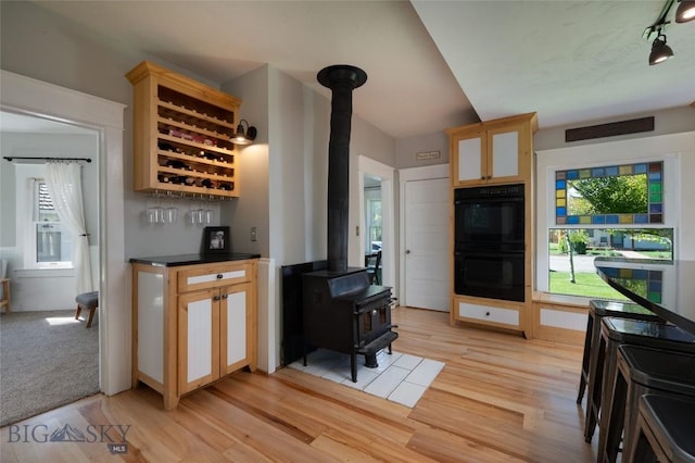 311 N 6th St, Manhattan, MT 59741 - bar area with a wood stove, light wood finished floors, and rail lighting