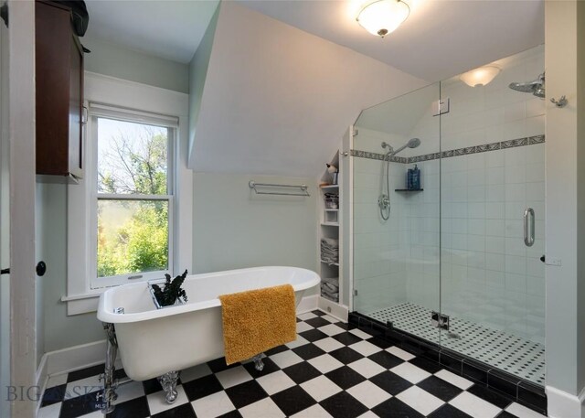 311 N 6th St, Manhattan, MT 59741 - bathroom with a stall shower, a freestanding bath, tile patterned floors, and vaulted ceiling