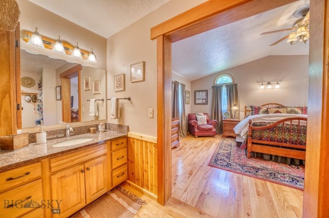 886 Wierda Way, Manhattan, MT 59741 - full bathroom with wood finished floors, ceiling fan, vaulted ceiling, ensuite bath, and vanity