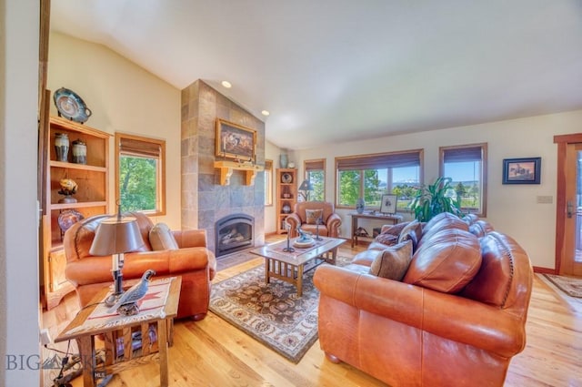 886 Wierda Way, Manhattan, MT 59741 - living room featuring lofted ceiling, light wood-type flooring, a tiled fireplace, and recessed lighting