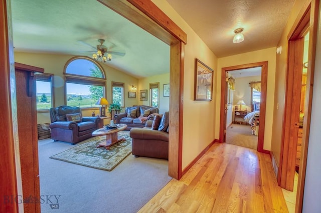 886 Wierda Way, Manhattan, MT 59741 - living room with ceiling fan, vaulted ceiling, light wood-style flooring, and light carpet