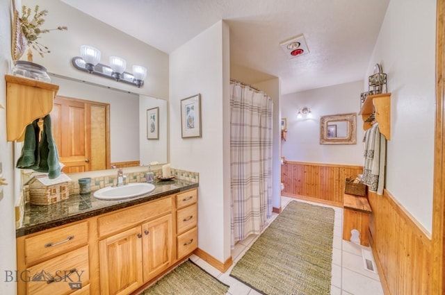 886 Wierda Way, Manhattan, MT 59741 - bathroom featuring wood walls, wainscoting, vanity, tile patterned flooring, and curtained shower