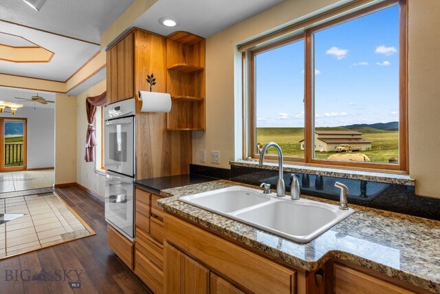 6385 Mt Highway 41, Whitehall, MT 59759 - kitchen with double oven, brown cabinets, open shelves, healthy amount of natural light, and recessed lighting