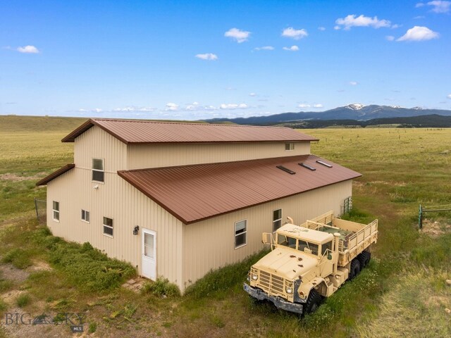 6385 Mt Highway 41, Whitehall, MT 59759 - rear view of house with a pole building, a metal roof, a mountain view, and an outdoor structure
