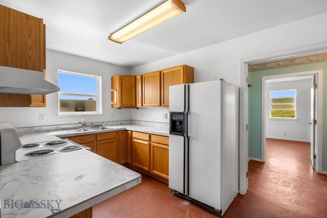 6385 Mt Highway 41, Whitehall, MT 59759 - kitchen with white appliances, plenty of natural light, light countertops, and brown cabinetry