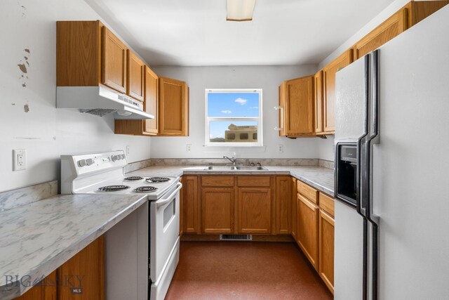 6385 Mt Highway 41, Whitehall, MT 59759 - kitchen featuring white appliances, under cabinet range hood, light countertops, and brown cabinetry