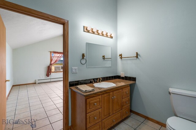 6385 Mt Highway 41, Whitehall, MT 59759 - half bath with a baseboard heating unit, tile patterned floors, lofted ceiling, and vanity
