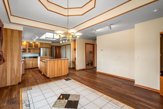 6385 Mt Highway 41, Whitehall, MT 59759 - kitchen featuring dark wood-style flooring, freestanding refrigerator, a chandelier, and track lighting