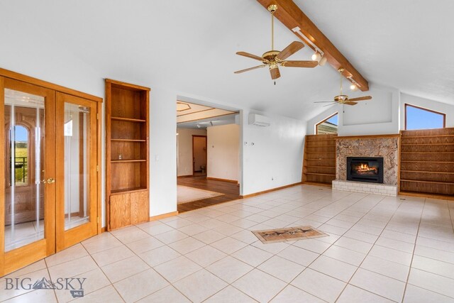 6385 Mt Highway 41, Whitehall, MT 59759 - unfurnished living room featuring french doors, ceiling fan, light tile patterned floors, a glass covered fireplace, and built in features