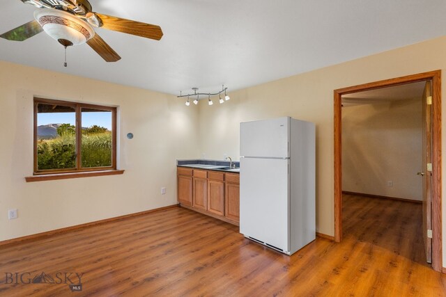 6385 Mt Highway 41, Whitehall, MT 59759 - kitchen featuring freestanding refrigerator, light wood-style flooring, and a ceiling fan