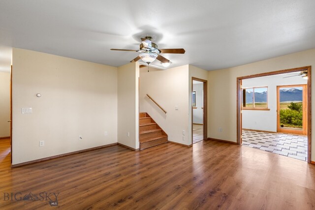 6385 Mt Highway 41, Whitehall, MT 59759 - unfurnished living room with ceiling fan, stairs, and wood finished floors
