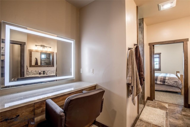 8 Sunset Ct, Ennis, MT 59729 - bathroom with stone finish flooring, vanity, and connected bathroom
