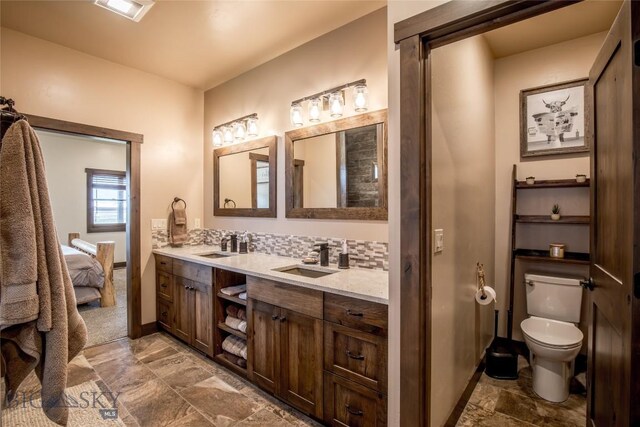 8 Sunset Ct, Ennis, MT 59729 - full bathroom with double vanity, ensuite bath, and stone finish floors