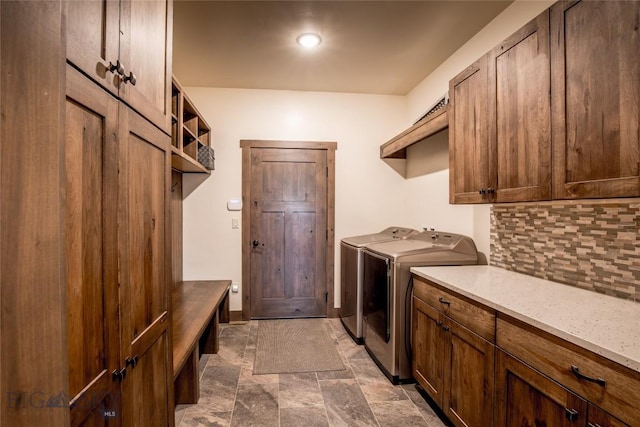 8 Sunset Ct, Ennis, MT 59729 - laundry area with washer and clothes dryer, cabinet space, and stone finish flooring