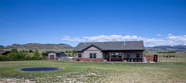 8 Sunset Ct, Ennis, MT 59729 - rear view of house featuring a mountain view, a storage shed, a fenced backyard, and a patio