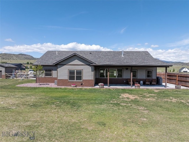 8 Sunset Ct, Ennis, MT 59729 - rear view of property with a patio area, a mountain view, and roof with shingles
