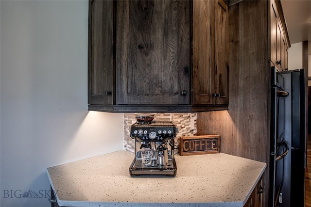8 Sunset Ct, Ennis, MT 59729 - kitchen view of dark brown cabinetry, tasteful backsplash, and light countertops