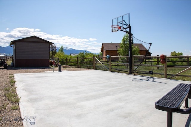 8 Sunset Ct, Ennis, MT 59729 - view of patio / terrace featuring a mountain view, a storage unit, and basketball hoop