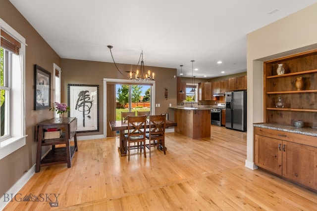 109 Baker St, Belgrade, MT 59714 - dining space with light wood finished floors, plenty of natural light, a chandelier, and recessed lighting