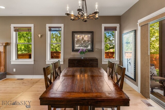 109 Baker St, Belgrade, MT 59714 - dining space with light wood-type flooring, a chandelier, and recessed lighting