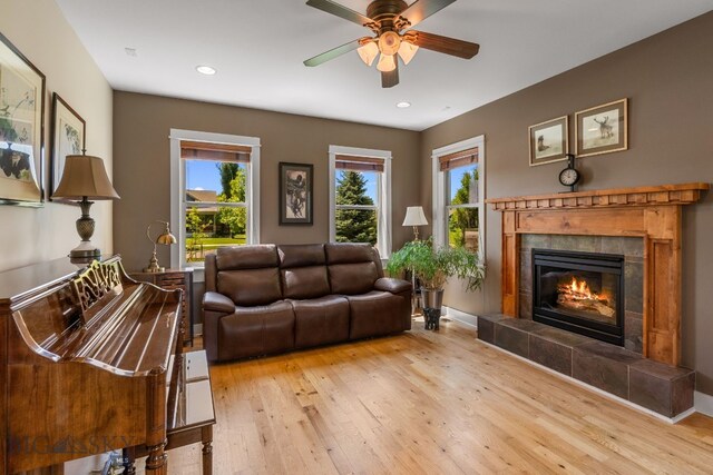 109 Baker St, Belgrade, MT 59714 - living area with a tile fireplace, a ceiling fan, light wood-style floors, plenty of natural light, and recessed lighting
