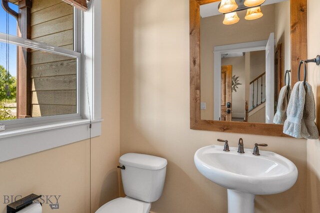 109 Baker St, Belgrade, MT 59714 - half bathroom featuring toilet and a chandelier