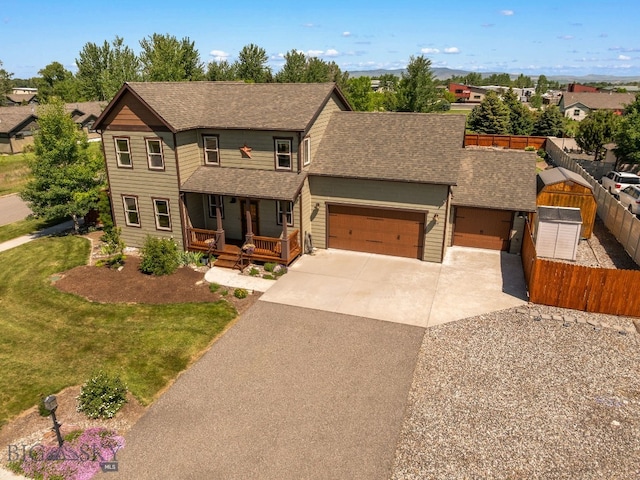 109 Baker St, Belgrade, MT 59714 - view of front facade featuring a porch, roof with shingles, an attached garage, concrete driveway, and a residential view