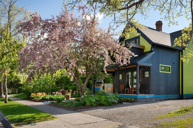 401 S Bozeman Ave, Bozeman, MT 59715 - view of property exterior with a sunroom, a chimney, and a shingled roof