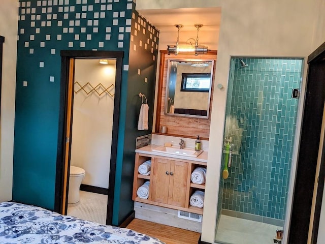 401 S Bozeman Ave, Bozeman, MT 59715 - bathroom with a stall shower, vanity, and wood finished floors