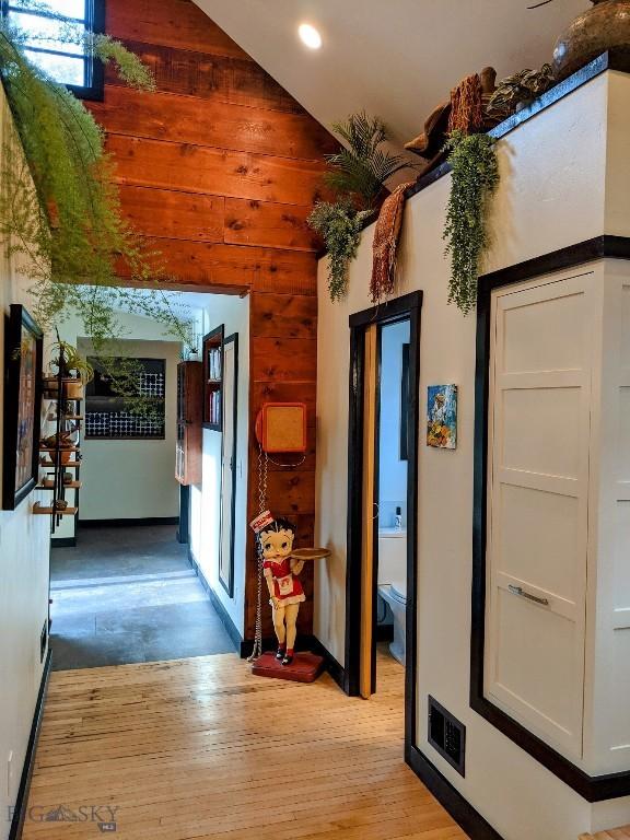 401 S Bozeman Ave, Bozeman, MT 59715 - hall featuring light wood-style flooring, wood walls, high vaulted ceiling, and recessed lighting