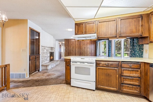 117 Henderson St, Bozeman, MT 59715 - kitchen featuring white electric stove, under cabinet range hood, brown cabinets, and light countertops