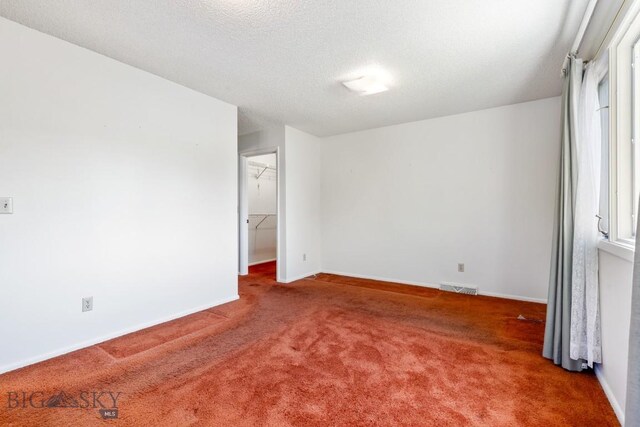 117 Henderson St, Bozeman, MT 59715 - carpeted empty room with baseboards and a textured ceiling